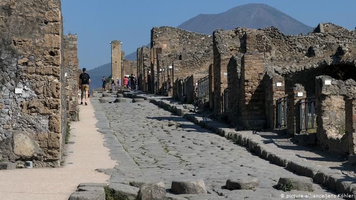 Ruins along a cobbled street in Pompeii Archaeological Park.