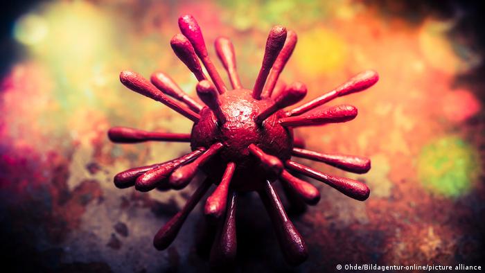 The illustration represents viruses and shows a red ball that is all nails