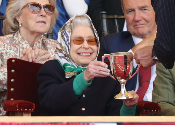 Prize winning: The Queen seemed very happy when she received the trophy.  Photo: Stephen Locke/Zuma Press/NTP