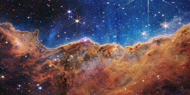 What looks like rocky mountains on a moonlit night is actually the edge of the young star-forming region NGC 3324 in the Carina Nebula.  Taken in infrared light by the Near Infrared Camera (NIRCam) on NASA's James Webb Space Telescope, this image reveals previously obscured regions of star birth.